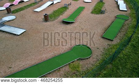Minigolf Course In Park Catch Golf Balls Behind Obstacle. Game For Points Below Par Or Above Par, Re