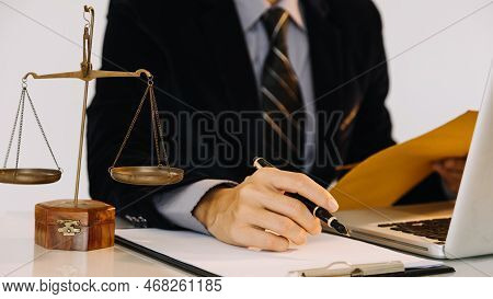 Business And Lawyers Discussing Contract Papers With Brass Scale On Desk In Office. Law, Legal Servi