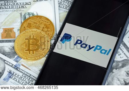 Paypal Logo On The Screen Smartphone With Bitcoin Cryptocurrency.