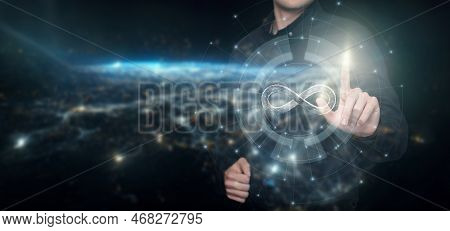 Concept Of Infinite Internet. A Man Clicks On The Infinity Icon On The Background Of Outer Space.