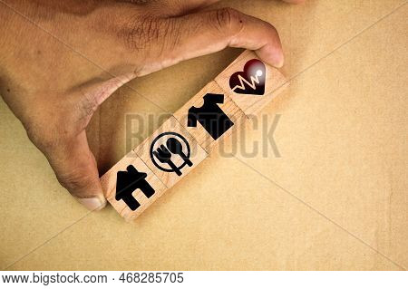 Wooden Cube With Icons Of Food, Clothing, Housing, Medicine, Four Basic Human Needs Concepts. Four B