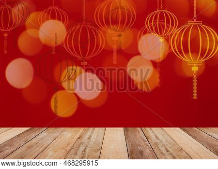 Wooden Table Top Over Golden Lantern Shape And Bokeh Pattern On Red Color For Chinese New Year Backg
