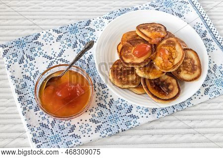 Appetizing Fresh Pancakes On A Plate With Apricot Jam In A Glass Bowl.