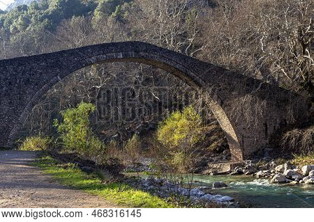 Ancient, Stony, Arched Bridge St. Vissarion On The Portaikos River In The Sunny Day (thessaly Region