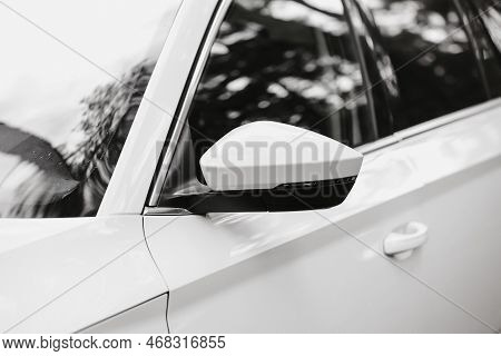 Left Rear View Mirror, Back View. Rear-view Mirror On A White Modern Car Outdoors. Vehicle Window Wi