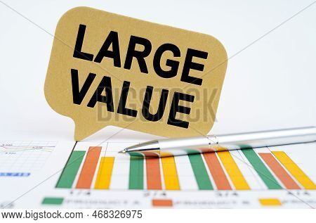 Business Concept. On The Financial Charts Lies A Pen And A Sign With The Inscription - Large Value