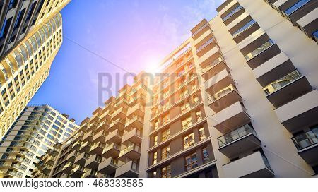 The Narrow Passage Between Modern Residential Buildings. Walls Of High-rise Apartment Buildings And 