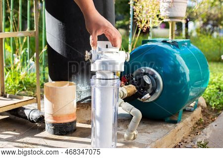 Water Supply System From A Well In A Country House. New Water Filter. Hydraulic Accumulator For Stor
