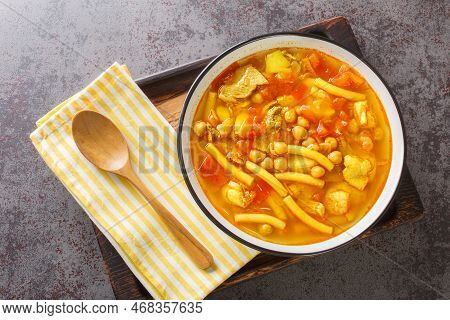 Vegetable Soup With Meat, Pasta And Chickpeas Close-up In A Plate On The Table. Horizontal Top View 