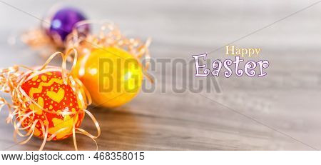 Close Up Of Colorful Easter Eggs On Wood Background.