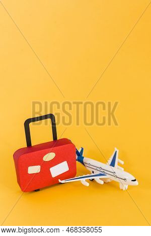 Travel And Tourism Concept, Suitcase And Airplane On Yellow Background. Minimal Style.
