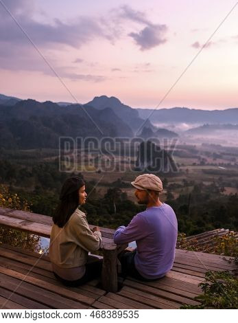 Couple Watching The Sunrise With Fog At Phu Langka In Northern Thailand, Phu Langka National Park