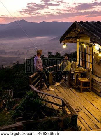 A Couple Watching The Sunrise With Fog At Phu Langka In Northern Thailand, Phu Langka National Park