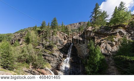 Lillaz Waterfall (cascate Di Lillaz) Splashes Alpine Water And Breaks Through Crevice Of Granite Roc