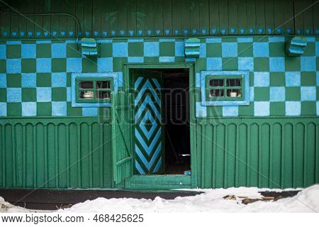Krasnoilsk, Ukraine - 13 Jan 2017: Green And Blue Traditional Wall Of A House In A Ukrainian Village