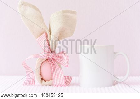 Easter Mockup White Coffee Mug With Rabbit Ears At Egg On Pink Cover Background. Copyspace.