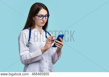 Female General Practitioner Medical Employee Reviewing Lab Results Using Smartphone, Medical App, Te