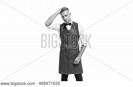 Serious Man In Bow And Bartender Apron Fixing Hair Isolated On White, Barkeeper