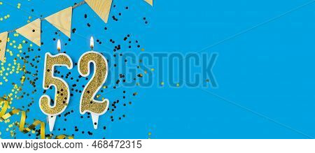 Golden Candle Number Fifty Two. Birthday Or Anniversary Card With The Inscription 52 On Blue Backgro
