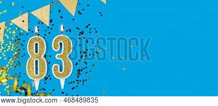 Golden Candle Number Eighty Three. Birthday Or Anniversary Card With The Inscription 83 On Blue Back