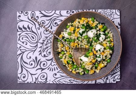 Salad Of Vegetables, Pasta And Mozzarella In A Dish On A Dark Background. Top View.