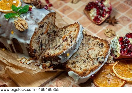 Christmas Stollen With Candied Fruit And Dried Fruits On Parchment. Stollen - Traditional German Bre