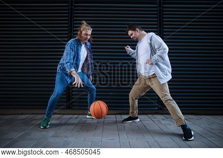 Man With Down Syndrome Playing Basketball Outdoor With His Friend. Concept Of Friendship And Integra
