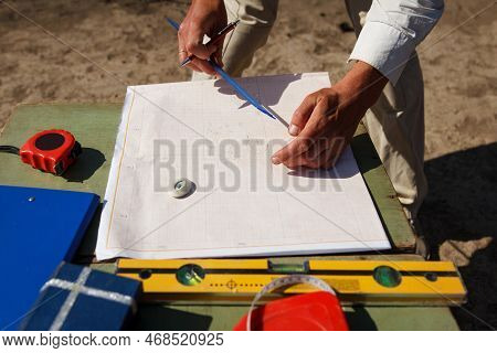 Archaeologist Designs, Draws With Pencil On Paper A Drawing Of Ancient Archaeological Artifacts Foun
