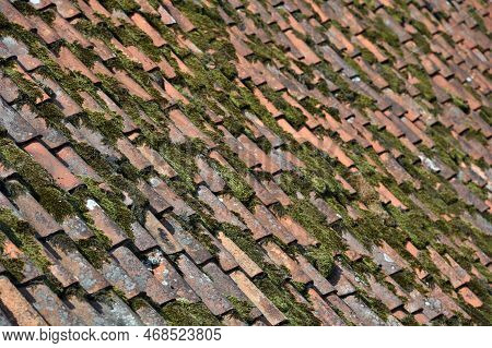 Roof Of Old Country House From Weathered Aged Clay Tiles Closeup, Old Cracked Tiled Roof