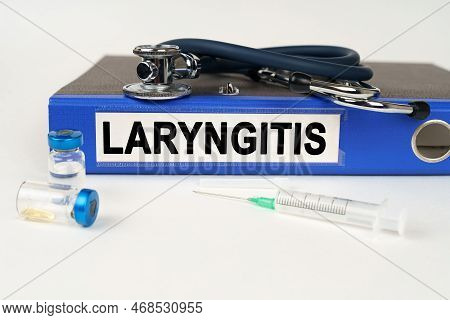 Medical Concept. On A White Surface, A Syringe, A Stethoscope And A Folder With The Inscription - La