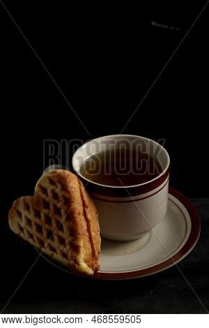Wapili Or Wafili Cake And Tea Isolated On Black Background. Indonesian Cake