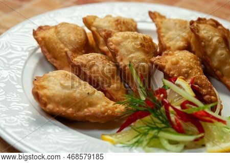 Asian Fried Dumplings On White Dish. Fried Dumplings Gyoza With Soy Sauce, And Chopsticks, Selective