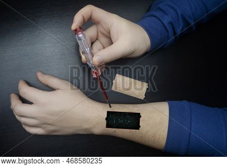 Robot Arm Concept. Man Shows Biomechanical Prosthetic Hand. Guy Repairs His Hand With Tool. Bioengin