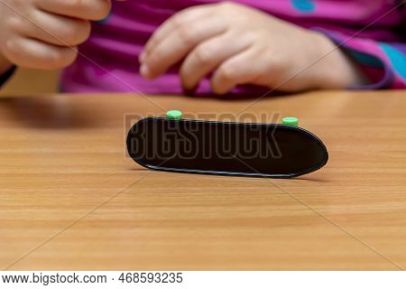 The Fingerboard Lies Upside Down On A Wooden Table, Close-up, Selective Focus.finger Training.