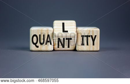 Quality And Quantity Symbol. Concept Word Quality Quantity On Wooden Cubes. Beautiful Grey Table Gre