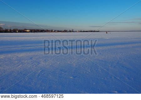 Frozen Lake Logmozero, Karelia, Russia. Winter January In Nature. Smooth Blue Ice Surface Covered Wi