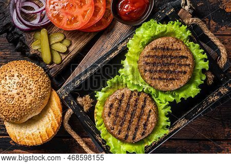 Cooking Plant Based Meatless Burgers With Vegetarian Meat Free Roasted Cutlets, Patties, Tomato And 