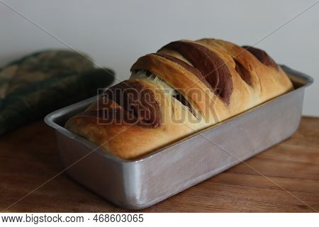 Vanilla Chocolate Swirl Bread Inside Loaf Tin Taken Out Of Oven