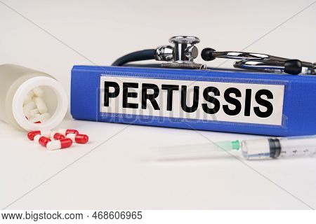 Medical Concept. On A White Surface There Are Pills, A Syringe, A Stethoscope And A Folder With The 