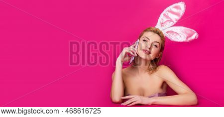 Easter Banny Woman Talking On Smartphone Isolated On Pink. Horizontal Photo Banner For Website Heade