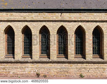 An Old Church With Medieval Windows At Daylight, Sunlight, Bergues (france)