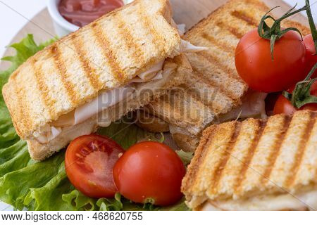 Tasty Club Sandwiches With Ham And Cheese On Wooden Table. Grilled And Pressed Toast With Smoked Ham
