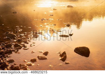 Warmy Golden Sunlight On Quiet Water Surface Of Lake, Orange Haze, Ripple Sun Glares, Blinks, Reflec