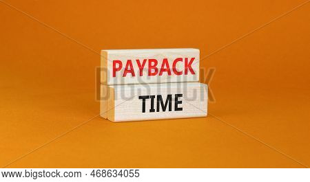 Payback Time Symbol. Concept Words Payback Time On Wooden Blocks. Beautiful Orange Table Orange Back