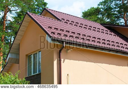 New Metal Roofing Construction With Rain Gutter System And Roof Protection From Snow Board.