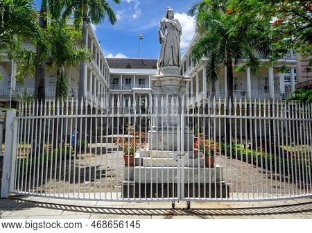 Port Louis, Mauritius, December 2021 - Main Gate Of The Government House, With The Statue Of Queen V