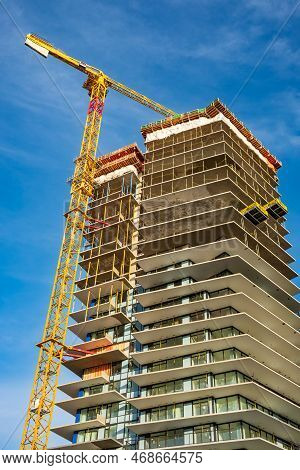 Building Site With Cranes New Development In The City. Concrete High Rise Residential Building Under