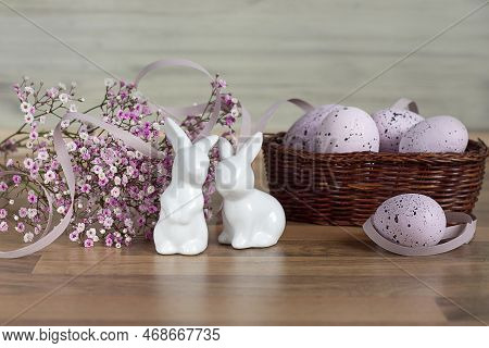 Easter Background With Colored Easter Eggs And Blooming Flowers. Two Easter Bunnies. Easter Composit