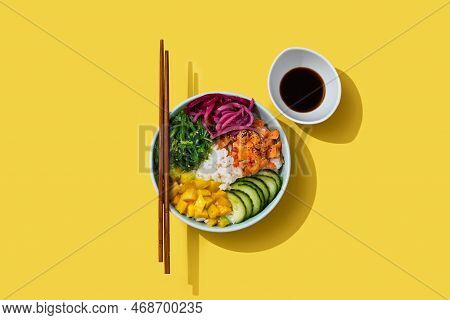 Poke Bowl With Rice, Salmon,cucumber,mango,onion,wakame Salad, Poppy Seeds Ands Sunflowers Seeds On 