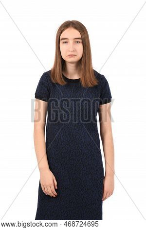 Young Beautiful Girl In A Dark Blue Dress On A White Background, Sad Expression Like A Smooth-head B